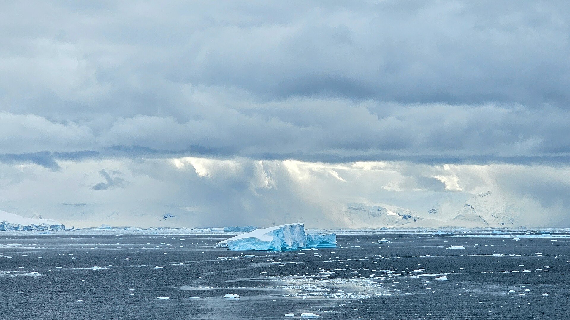 Iceberg adrift off Neko Harbour under a heavy Antarctic sky