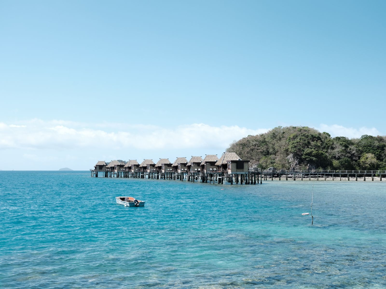 Overwater bures on stilts at a Fiji island resort