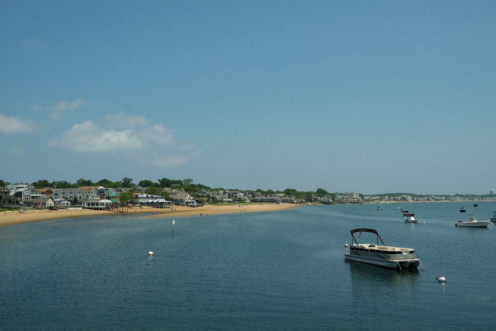 Moored boats off the Nantucket shore under clear summer skies