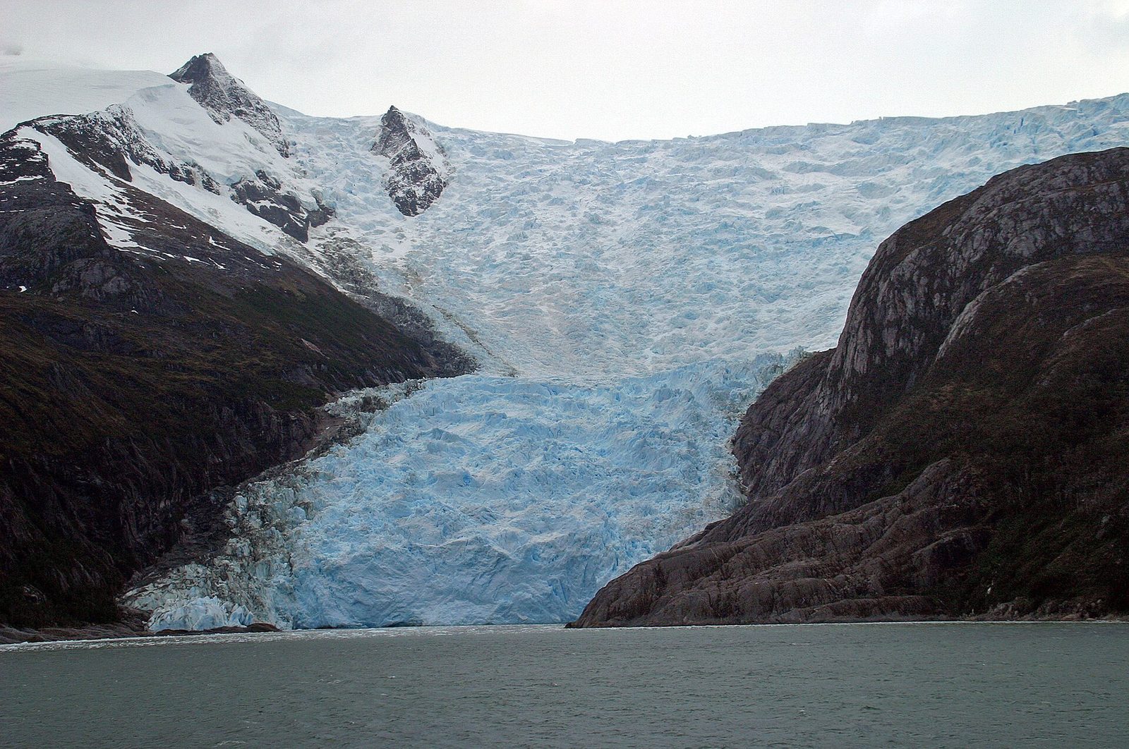 A tidewater glacier spilling to the sea along the Beagle Channel's Glacier Alley