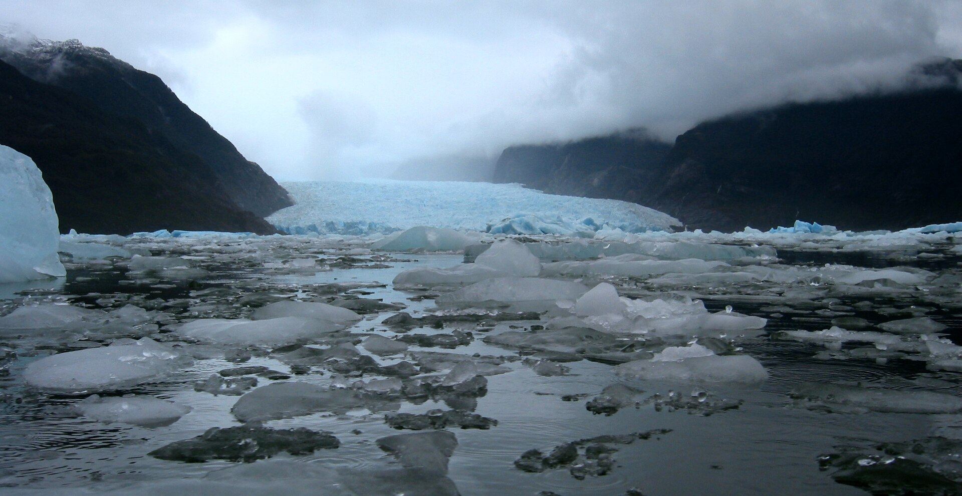 Brash ice on Laguna San Rafael beneath low cloud