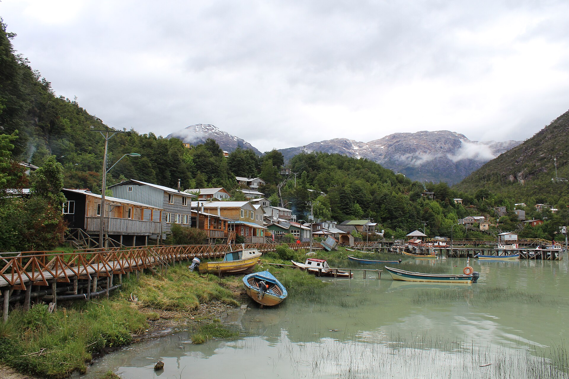 Cypress boardwalks and fishing boats at Caleta Tortel