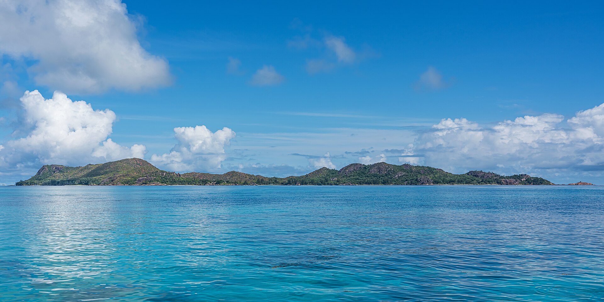 Curieuse Island's bare red earth coastline and forest
